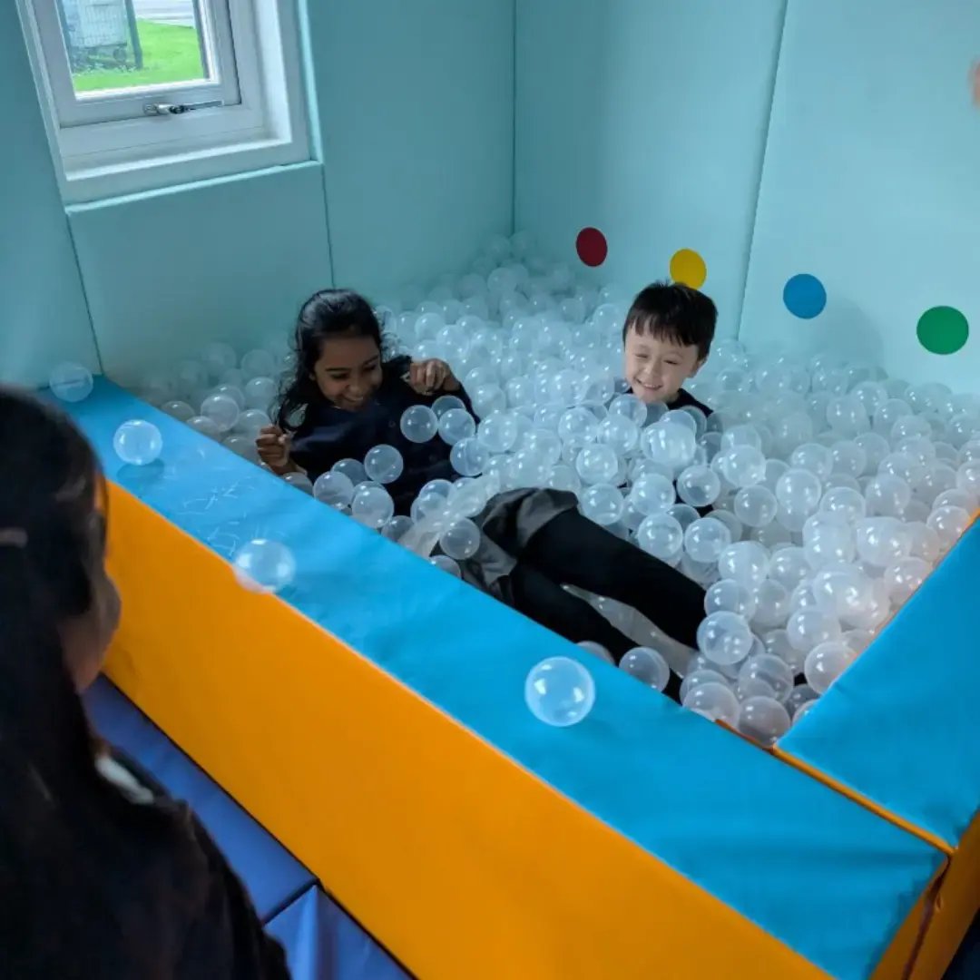 pupils in a ball pit in custom sensory room at school