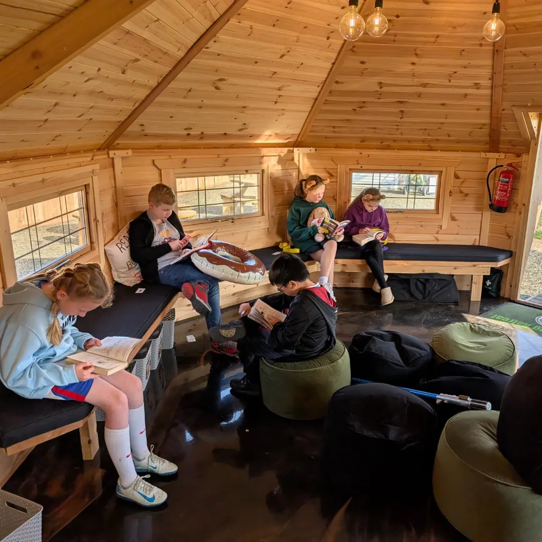 pupils accessing books in their library cabin