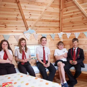 students inside their wellbeing log cabin