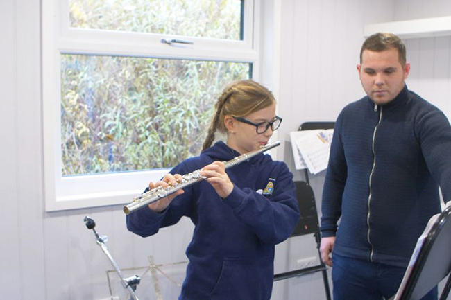 Music room studio pupil practising with teacher_a